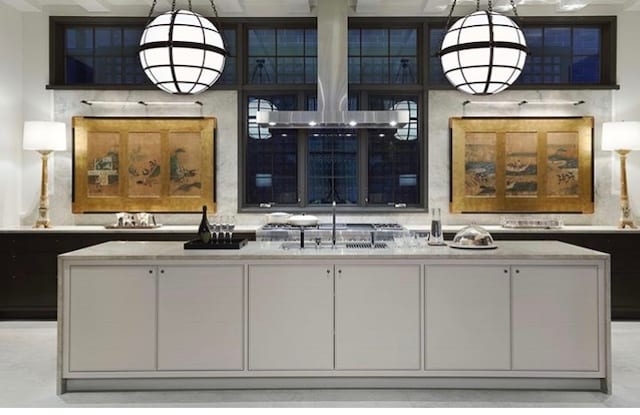 bar featuring white cabinets, light stone countertops, sink, and pendant lighting