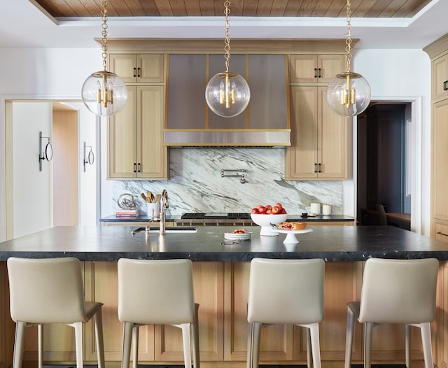 kitchen featuring wooden ceiling, backsplash, and a center island with sink