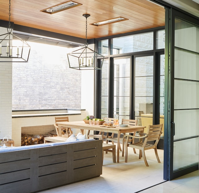 interior space featuring floor to ceiling windows, a chandelier, and wooden ceiling