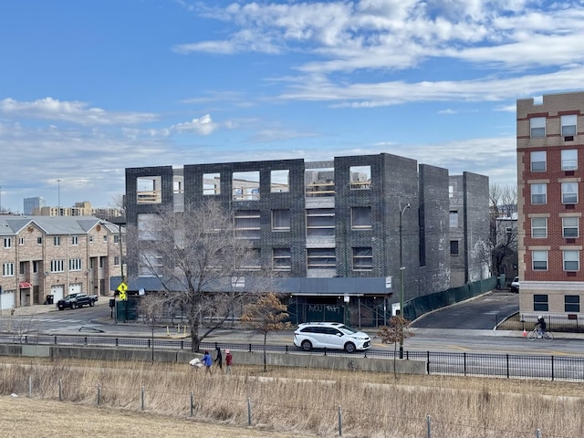 view of building exterior with fence