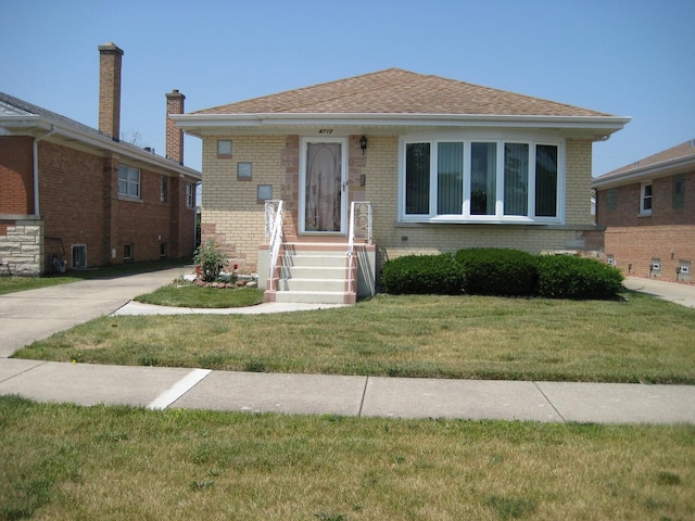 bungalow-style home with brick siding, a front yard, and central AC unit