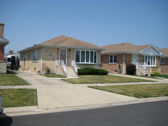 view of front of house with brick siding and a front yard