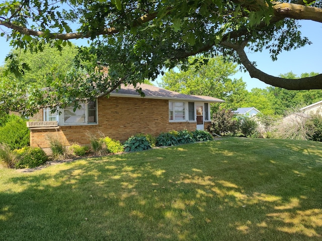 view of home's exterior with a lawn