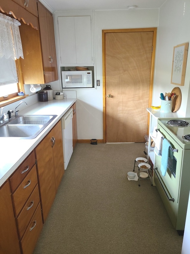 kitchen featuring light colored carpet, white appliances, and sink