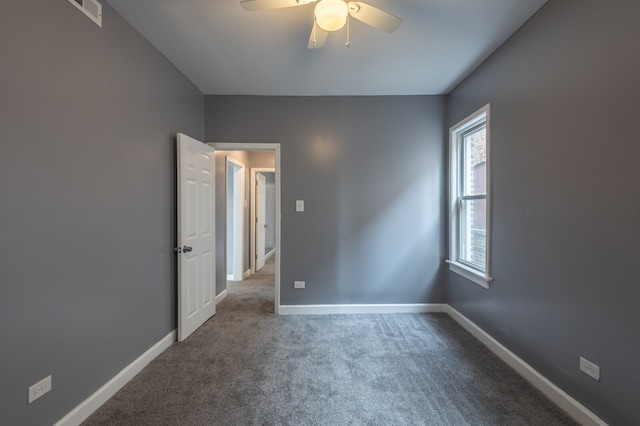 carpeted empty room featuring ceiling fan