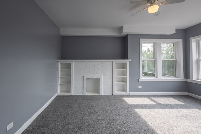 unfurnished living room featuring a fireplace, carpet flooring, and ceiling fan