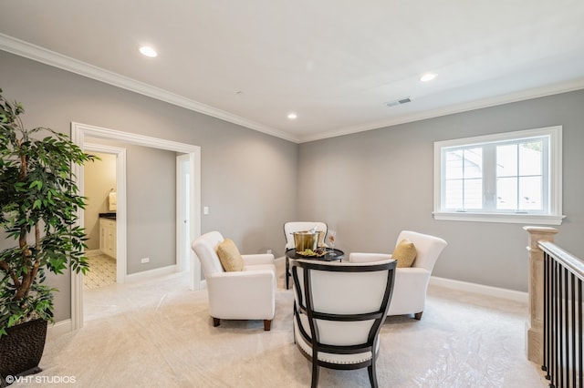 sitting room with light carpet and crown molding