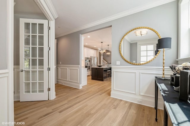 1062 Livingston Ave, Highland Park, IL 60035 - entryway featuring a decorative wall, light wood-style floors, ornamental molding, a wainscoted wall, and recessed lighting