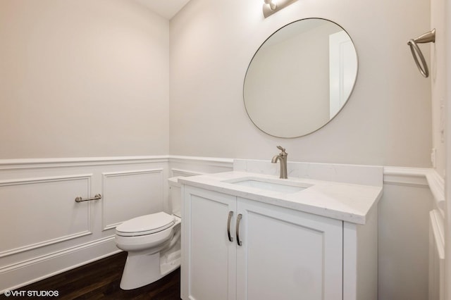 1060 Livingston Ave, Highland Park, IL 60035 - half bath with vanity, wainscoting, toilet, wood finished floors, and a decorative wall