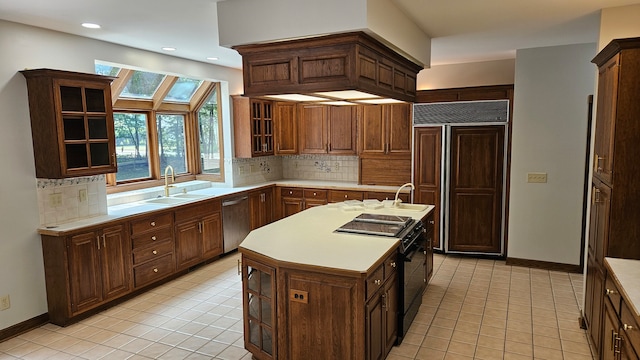 kitchen featuring dishwasher, paneled built in refrigerator, light countertops, black range with electric cooktop, and a sink