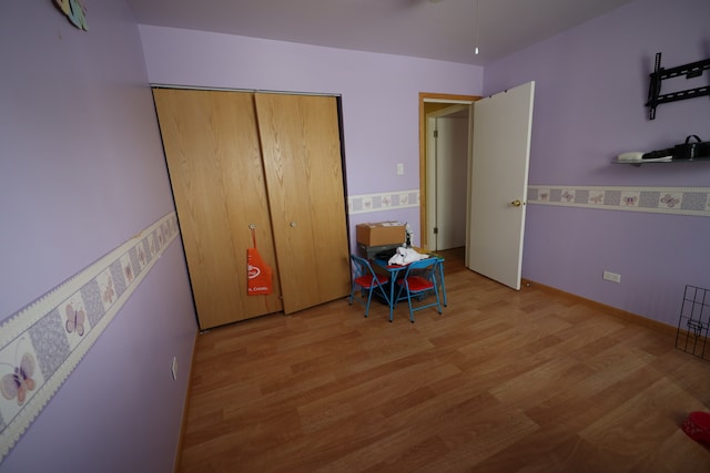 bedroom featuring light hardwood / wood-style floors and a closet