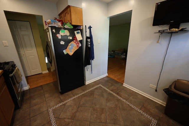 kitchen with dark wood-type flooring and black appliances