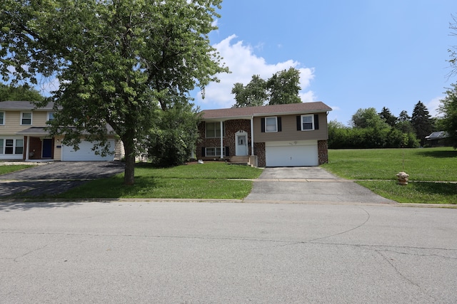 split foyer home featuring a front yard and a garage