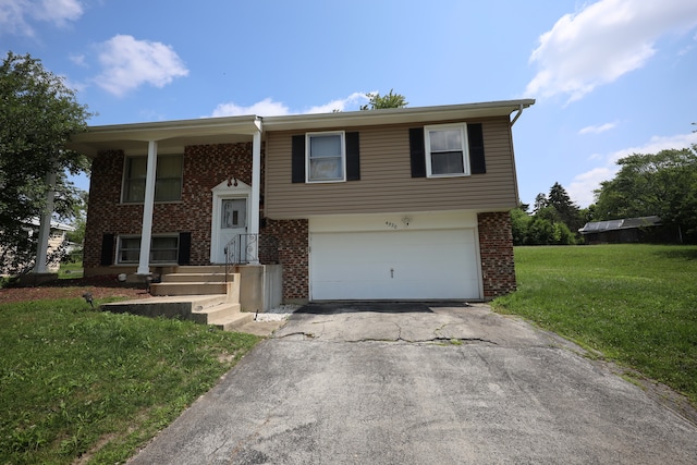 raised ranch with a front yard and a garage