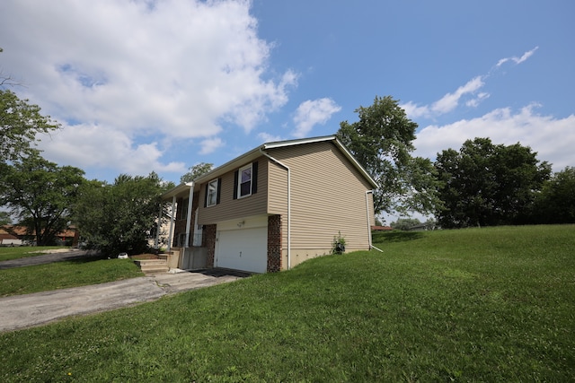 view of home's exterior featuring a lawn and a garage