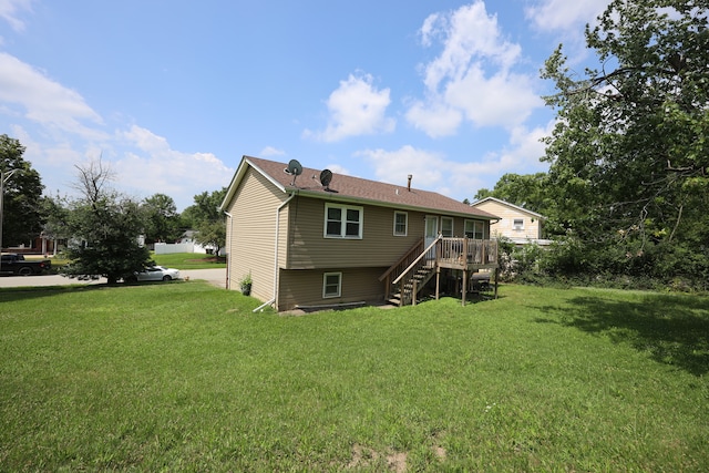 rear view of house featuring a deck and a lawn