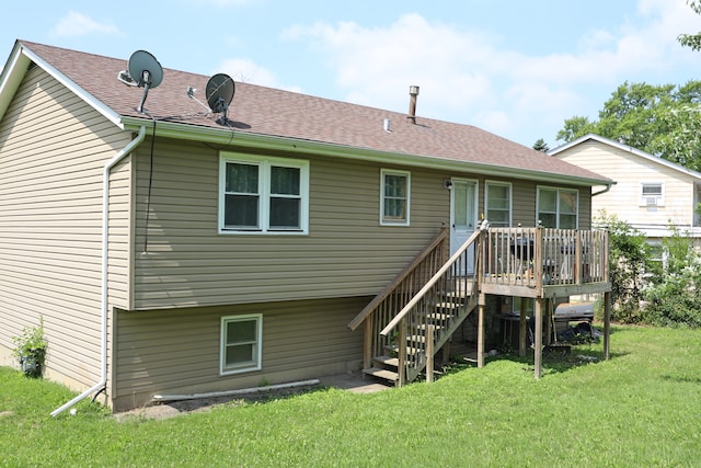 rear view of property featuring a wooden deck and a yard