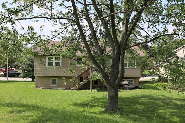 rear view of property with a yard