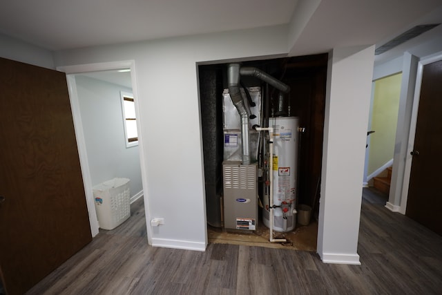 utility room featuring gas water heater and heating utilities