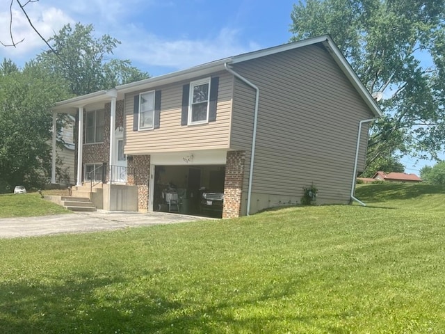 back of property with a lawn and a garage