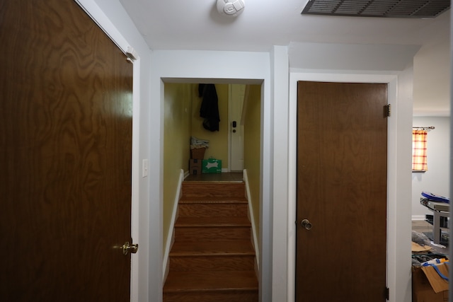 stairway featuring dark wood-type flooring