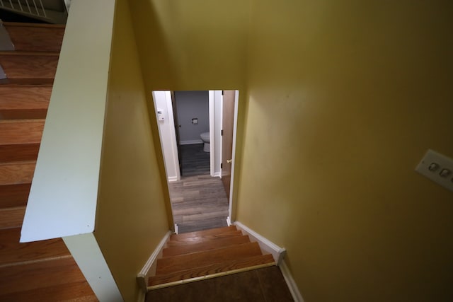 stairway featuring dark hardwood / wood-style floors