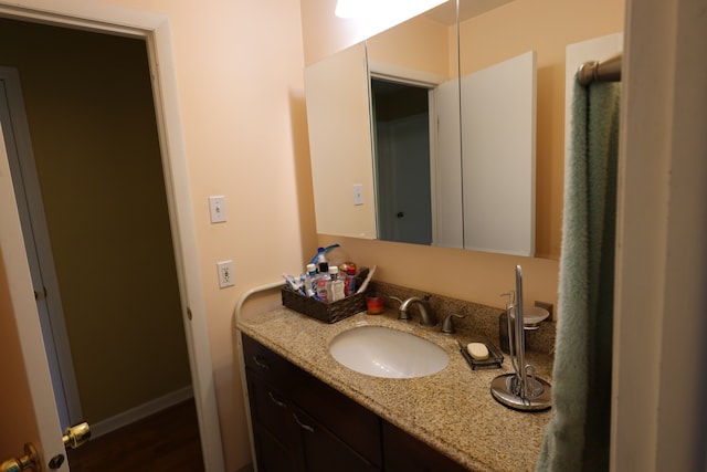 bathroom with vanity and hardwood / wood-style floors