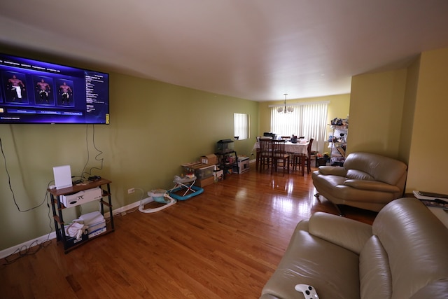 living room featuring a notable chandelier and hardwood / wood-style flooring