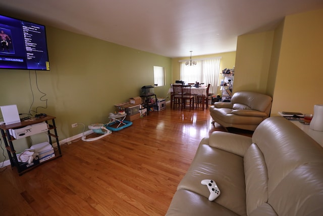 living room featuring a notable chandelier and hardwood / wood-style flooring