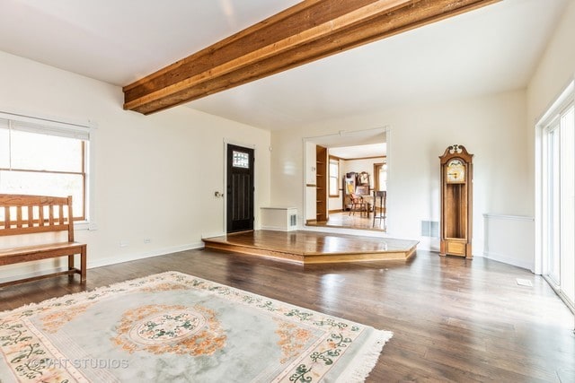 living room featuring beam ceiling and dark hardwood / wood-style flooring