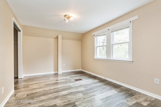 spare room featuring light hardwood / wood-style flooring