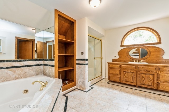 bathroom featuring tile floors, vanity, and separate shower and tub