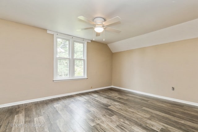 empty room featuring ceiling fan, lofted ceiling, and dark hardwood / wood-style flooring