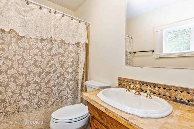 bathroom with toilet and oversized vanity