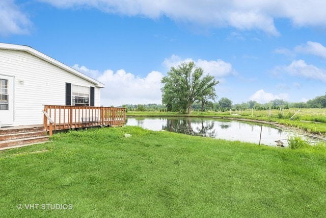 view of yard featuring a deck with water view