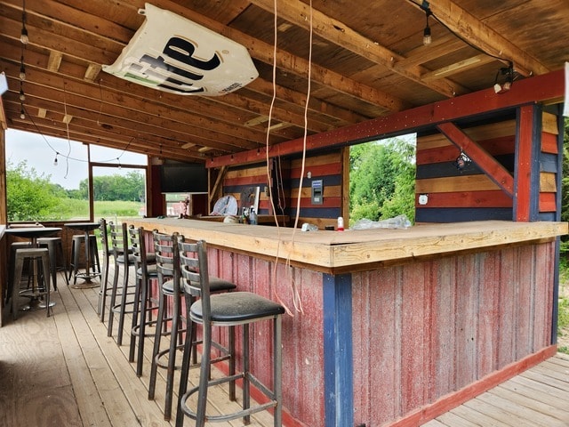 bar with light hardwood / wood-style flooring