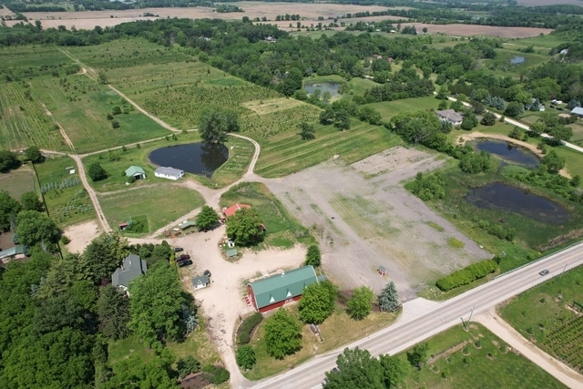 birds eye view of property featuring a rural view and a water view