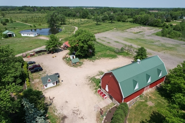 birds eye view of property featuring a rural view and a water view