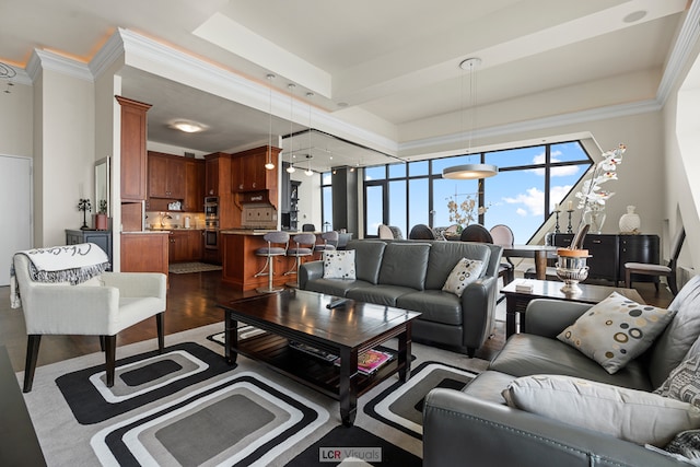 living room featuring hardwood / wood-style floors, crown molding, and a tray ceiling