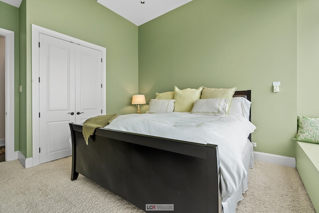 bedroom featuring light carpet and a closet