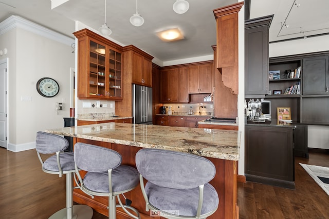 kitchen featuring stainless steel fridge, light stone countertops, and dark hardwood / wood-style flooring