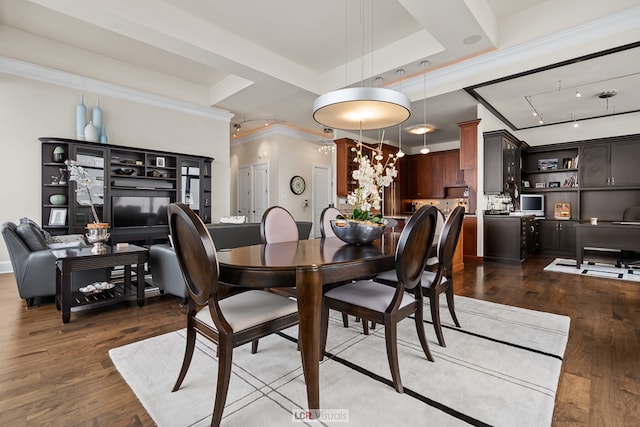 dining space with a chandelier, a tray ceiling, dark wood-type flooring, and ornamental molding