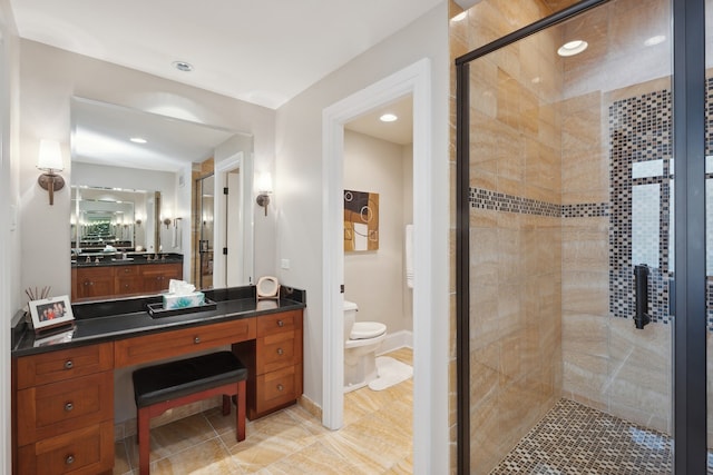 bathroom with an enclosed shower, vanity, tile flooring, and toilet