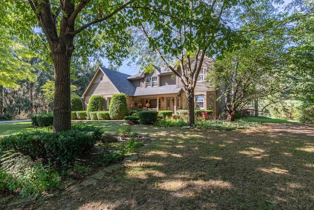 view of front of house with a porch and a front yard