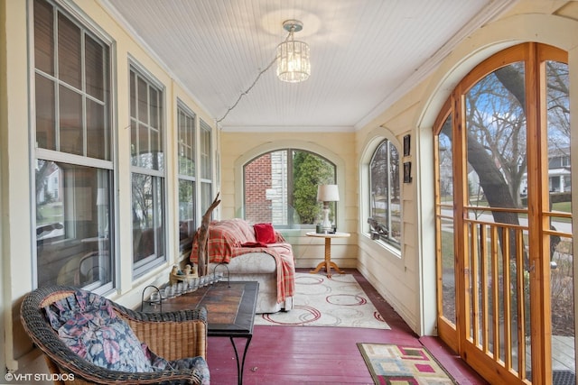 sunroom / solarium with an inviting chandelier