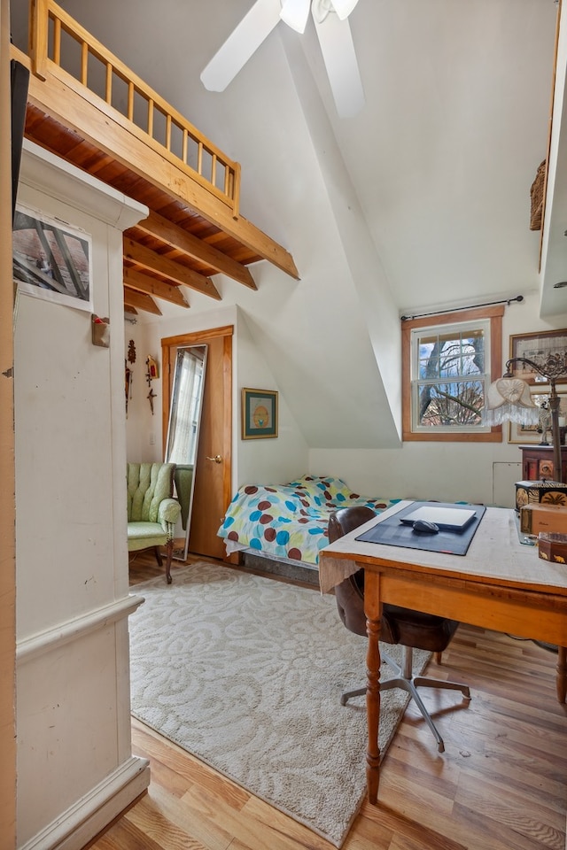 bedroom with ceiling fan, beam ceiling, wood-type flooring, and multiple windows