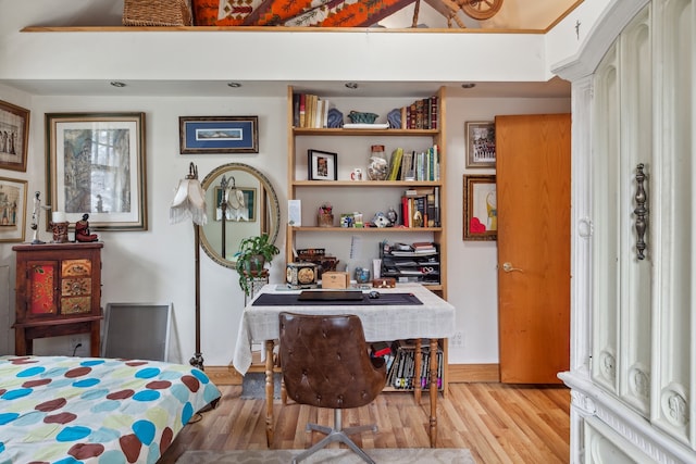 bedroom with light wood-type flooring and a high ceiling