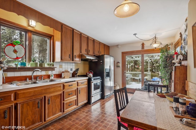 kitchen with decorative backsplash, sink, and appliances with stainless steel finishes