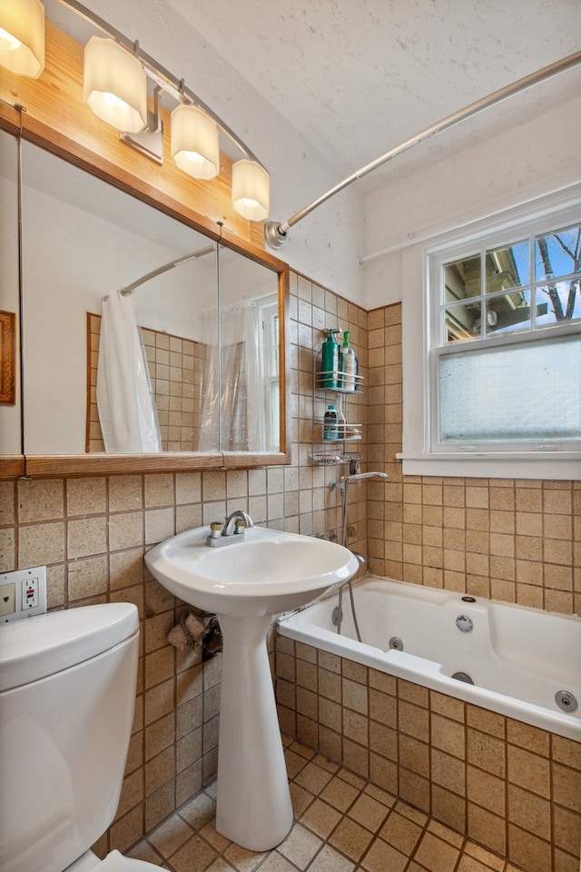 bathroom with tile patterned floors, tile walls, toilet, decorative backsplash, and shower / tub combo