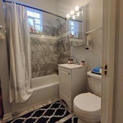 full bathroom with an inviting chandelier, toilet, shower / tub combo, and vanity